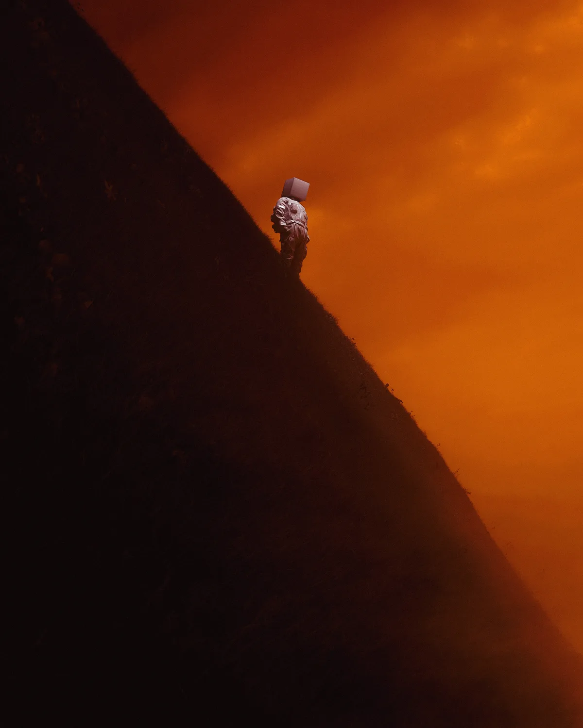A person in a bulky, light-colored outfit stands alone on a steep, dark hill under a dramatic orange sky, carrying a large…