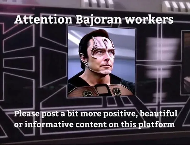 A screenshot of a Star Trek: Deep Space Nine scene shows a Bajoran official on a screen with overlaid text reading…