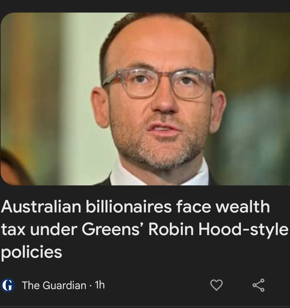A close-up photo of a man with glasses and a beard, wearing a suit and tie, appears in a news article screenshot from The…