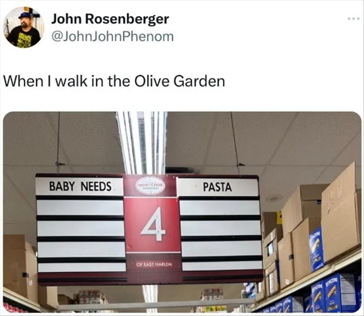 A photo of a store aisle sign with 'BABY NEEDS' on the left and 'PASTA' on the right, separated by a red section with the…