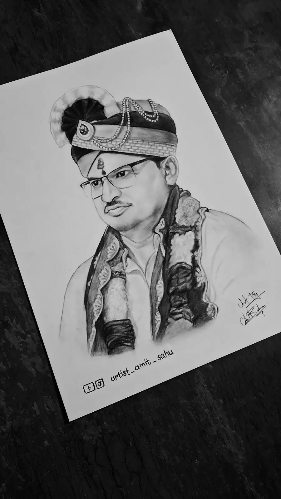 A black-and-white pencil sketch of a man wearing a traditional Indian turban with beads, glasses, and a patterned shawl…