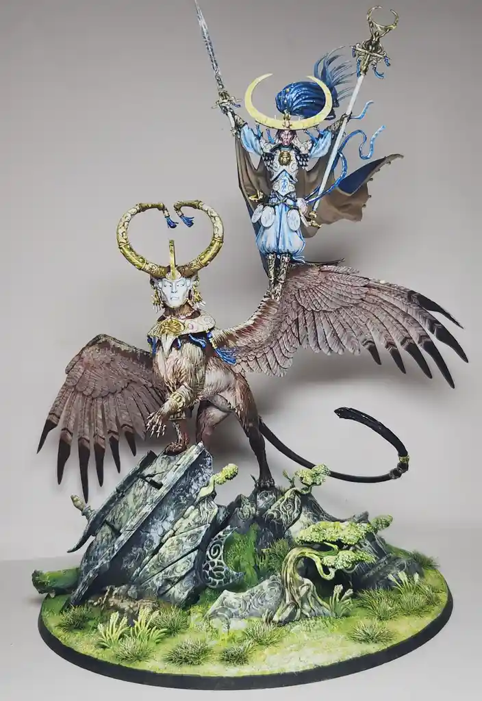 A highly detailed painted miniature depicts a winged, horned humanoid creature standing on a rocky, grassy base, with a…