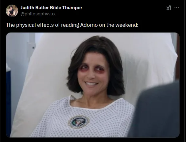 A woman with severe black eye and bruising around her eyes, wearing a hospital gown with a presidential seal, smiles while…