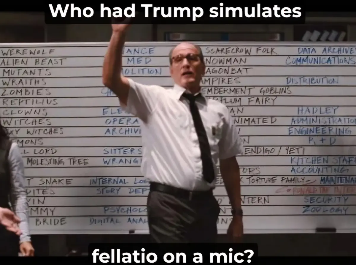 A man in a white shirt and black tie stands in front of a whiteboard filled with handwritten categories like 'WEREWOLF'…