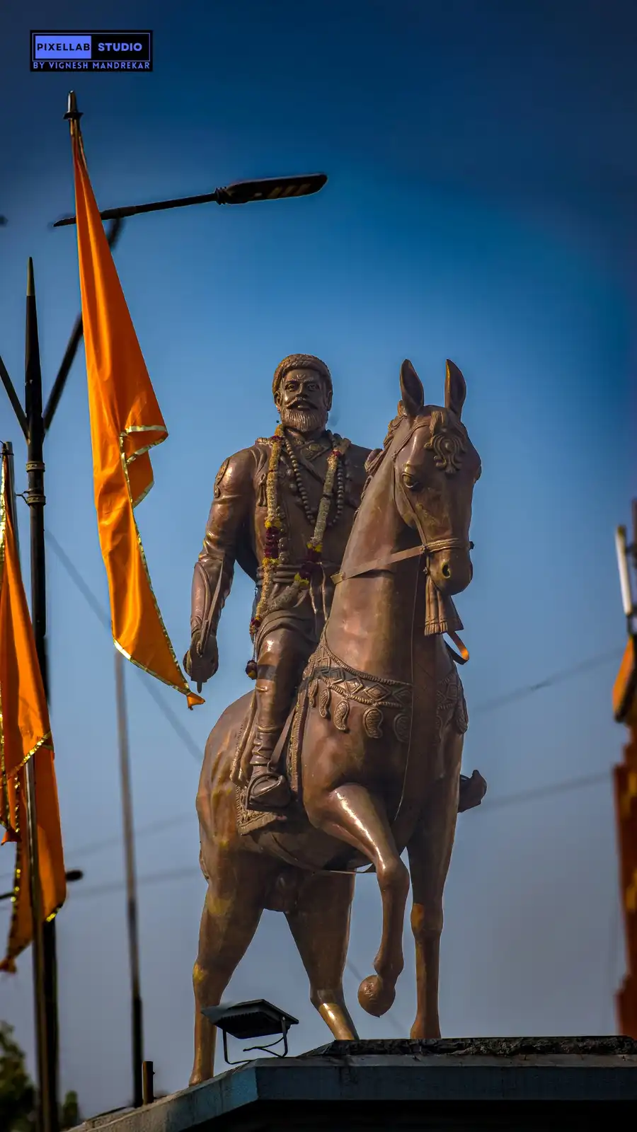 A bronze equestrian statue of a bearded man in traditional attire, mounted on a horse adorned with decorative harnesses and…