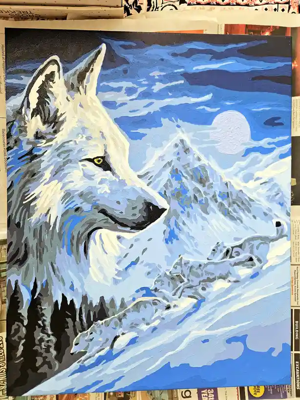 A stylized painting of a white wolf with yellow eyes, set against a snowy mountain landscape under a full moon. The wolf's…