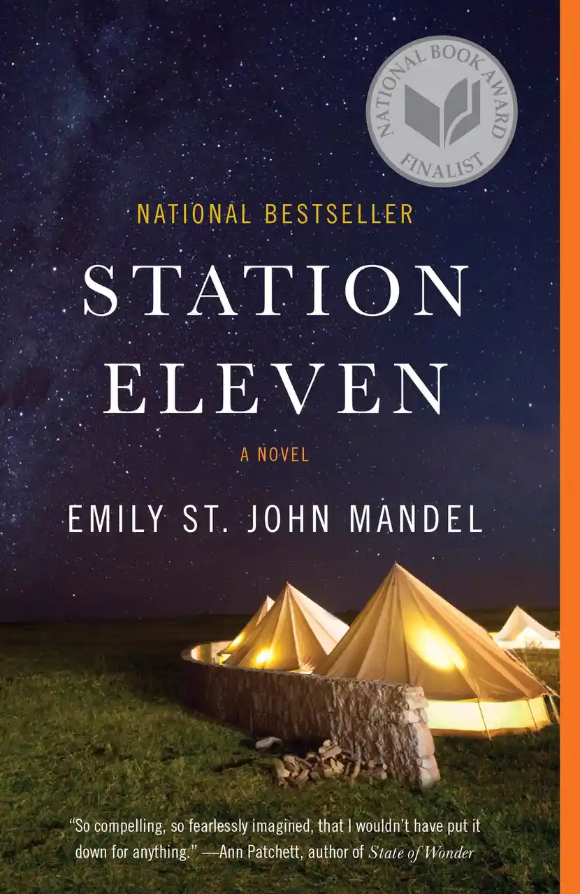 The image is the cover of the novel 'Station Eleven' by Emily St. John Mandel, featuring several illuminated bell tents…