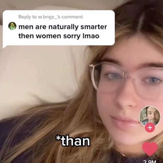 A young woman with glasses lies in bed, looking at the camera with a deadpan expression. A TikTok comment bubble above her…