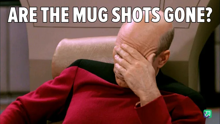 A bald man in a red Starfleet uniform sits in a chair, covering his face with his hand in a gesture of despair or…