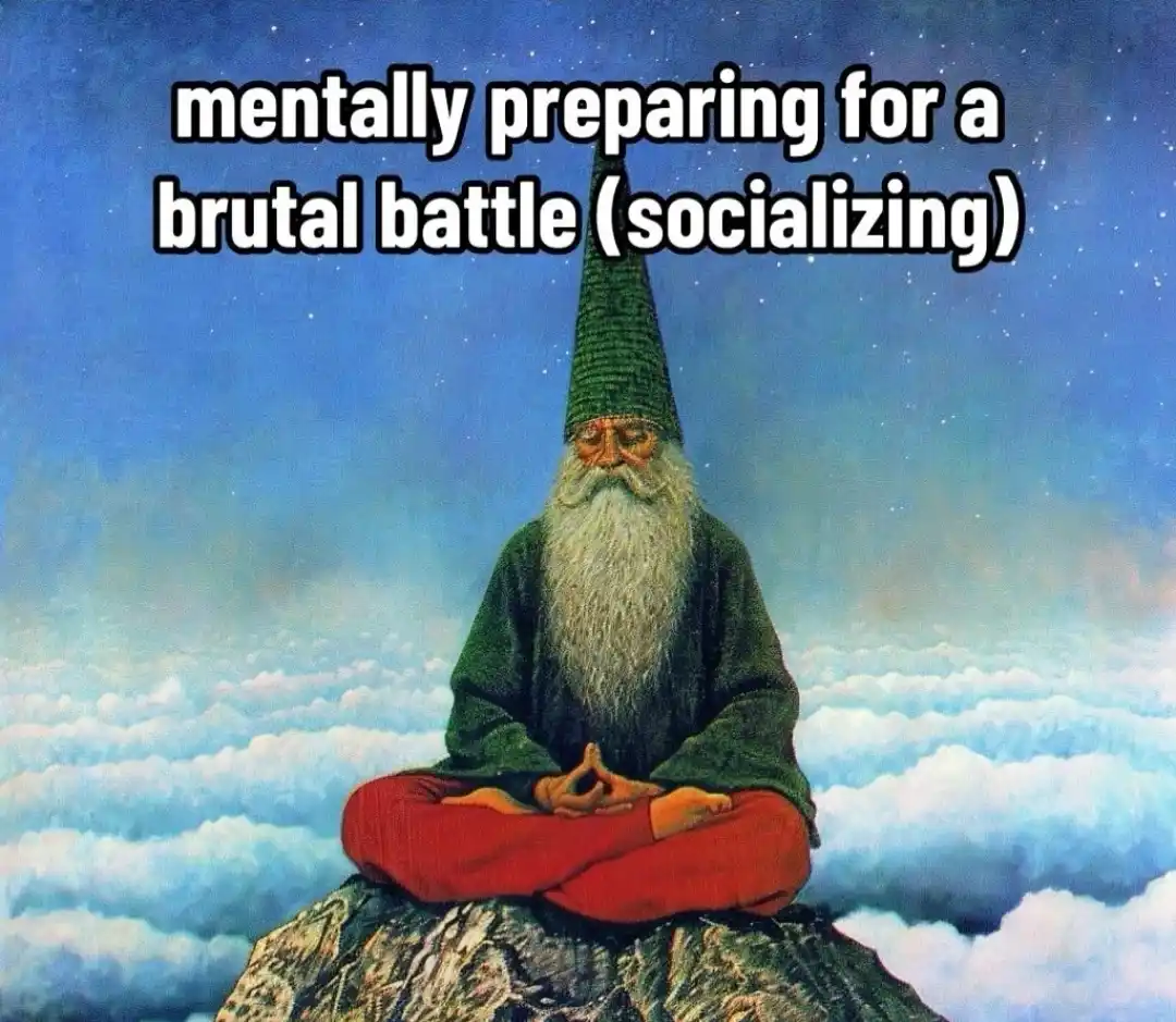 A painting depicts a gnome with a long white beard and green pointed hat, sitting cross-legged in meditation atop a rocky…
