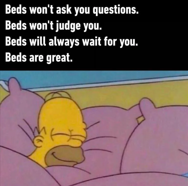 The image shows Homer Simpson sleeping peacefully in a bed with purple pillows and blankets. White text overlaid on a black…