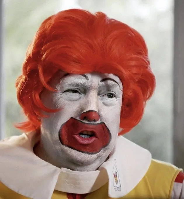 A person wearing a Ronald McDonald costume with a red wig, white face paint, and red nose, but their face is distorted with…