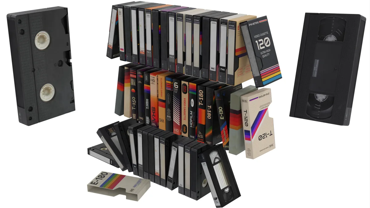 An image displays a large, organized collection of vintage VHS video cassettes and a single open VHS tape, arranged in…