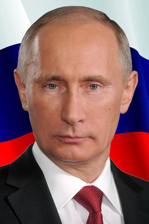 A formal portrait of Vladimir Putin, wearing a black suit, white shirt, and red patterned tie, set against a backdrop of the…