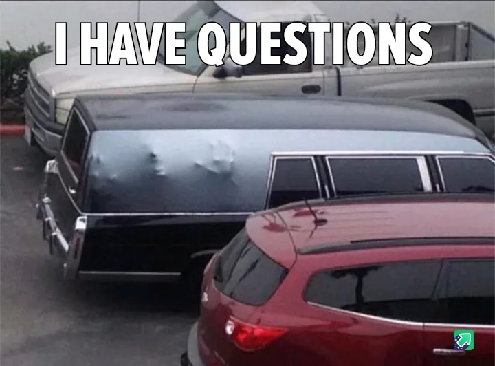 A black hearse is parked in a lot with a red car in front and a white truck behind. The hearse's rear window has smudges and…