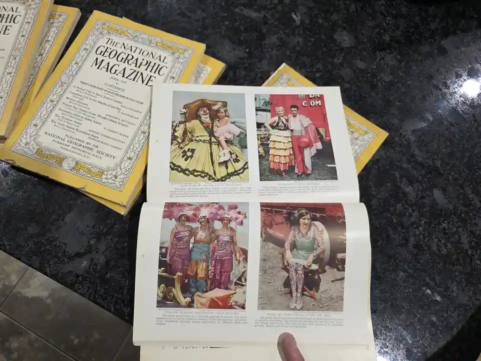 An open 1931 issue of National Geographic Magazine displays four vintage color photos of circus performers, including a…