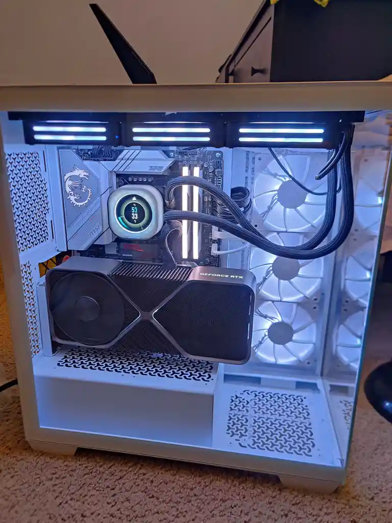 A white computer case with a transparent side panel shows its internal components, including a GeForce RTX graphics card, an…