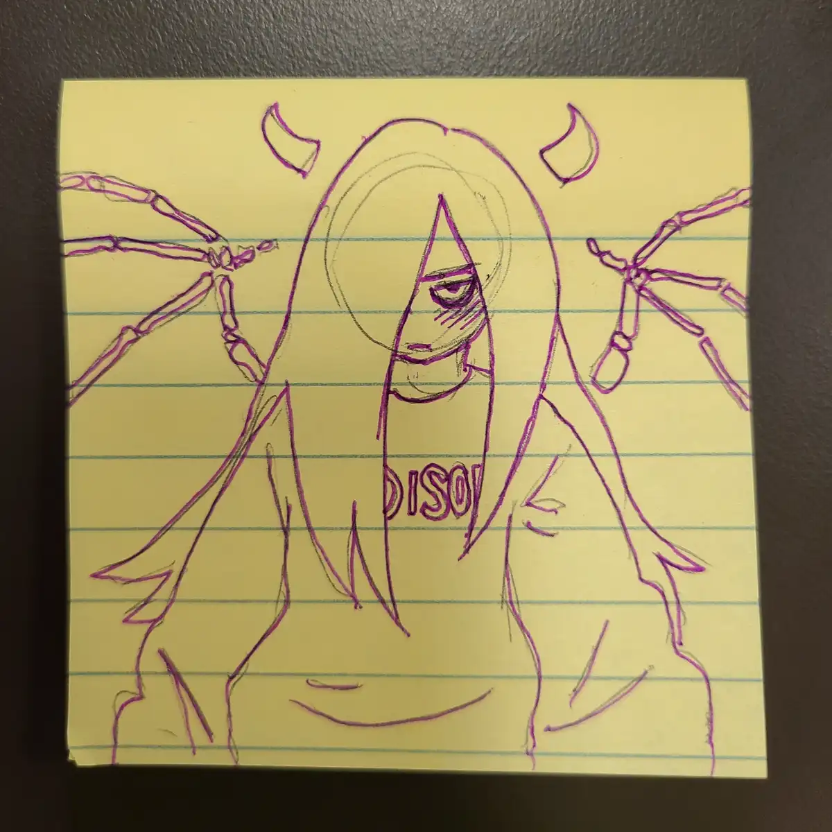 A hand-drawn sketch on a yellow legal pad shows a stylized figure with long hair, small horns, and skeletal spider-like…