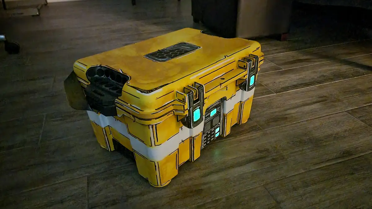 A real yellow and white plastic storage box sits on a wooden floor, but it's been heavily modified with black outlines…