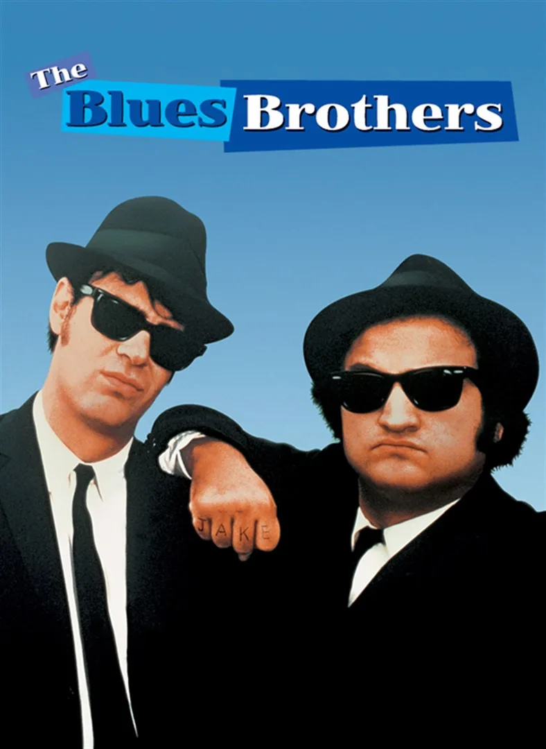 The poster for 'The Blues Brothers' shows two men in black suits, fedoras, and sunglasses standing against a blue…