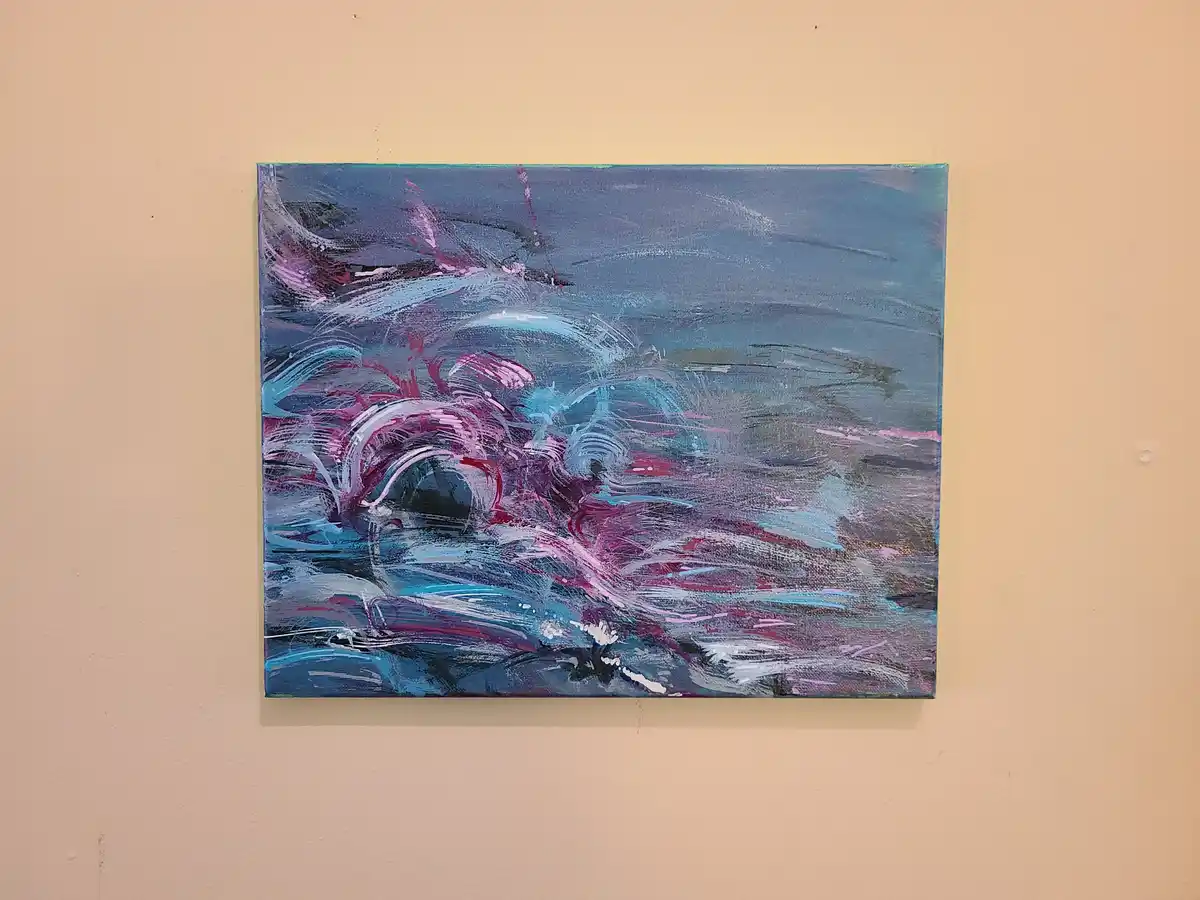 a rectangular abstract painting with swirling blue, purple, and white brushstrokes hangs on a beige wall, visually…