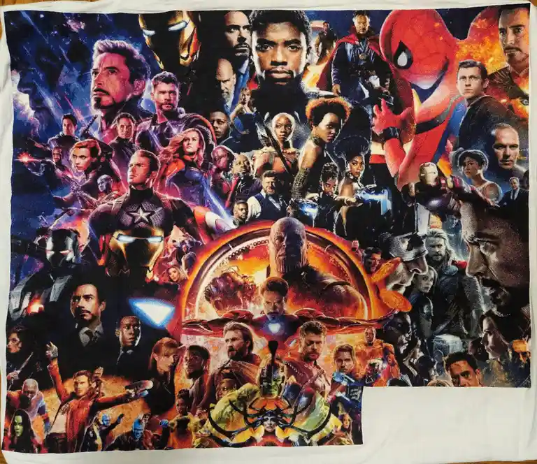 A printed towel displays a dense collage of Marvel superhero characters from the 'Avengers: Endgame' movie poster, including…