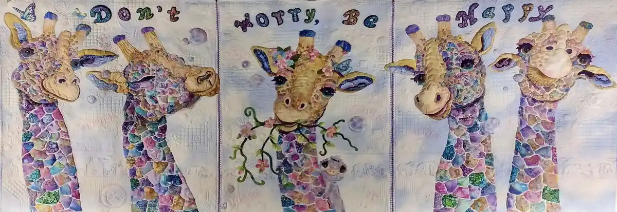 A colorful quilted artwork featuring four stylized giraffes with mosaic-patterned bodies in purples, blues, and greens. The…